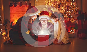 Merry Christmas! happy family mother father and child with magic