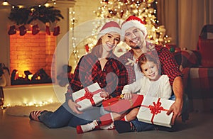 Merry Christmas! happy family mother father and child with magic