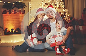 Merry Christmas! happy family mother father and child with magic