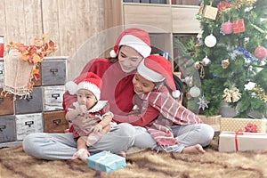 Merry Christmas and Happy Holidays! Cheerful mom and her cute daughters playing and have fun together