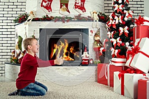 Merry Christmas and Happy Holidays!Cute child found many gifts under the Christmas tree.