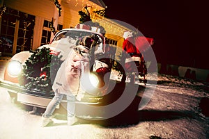 Merry Christmas and happy holidays! Cute little child girl waiting for Santa Claus