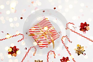 Merry Christmas and Happy Holidays frame banner with craft gift box, gold ribbons, light and candy cane. New Year holiday