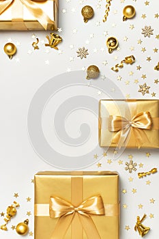 Merry Christmas and Happy Holidays greeting card. Beautiful golden gift balls ribbons confetti stars on gray background top view