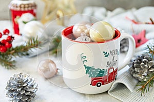 Merry Christmas and Happy Holidays greeting card New Year. Christmas mug with Christmas decorations and pine branches