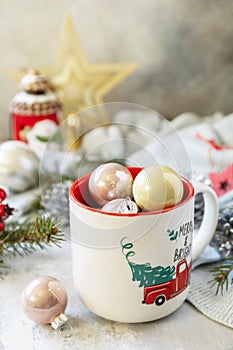 Merry Christmas and Happy Holidays greeting card New Year. Christmas mug with Christmas decorations and pine branches. Copy space