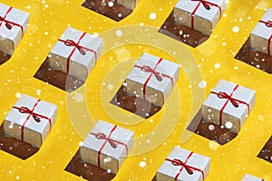 Merry Christmas and Happy new year 2019 Concept. Pattern Gift boxes on yellow background with lights snow