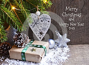 Merry Christmas and Happy New Year 2019 greeting card.Winter festive decoration with fir tree,garland lights,gift and toys.