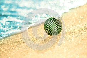 Merry Christmas and Happy New Year background, Christmas ball on the tropical beach near ocean