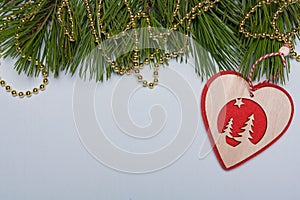 Merry Christmas, Happy New Year background, pine tree branches, golden beads, wooden toy heart. Border, card template, copy space