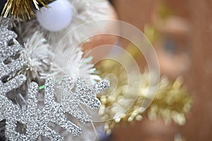 Merry christmas and happy new year Closeup of Christmas-tree and gold balls,white balls, tree branches on abstract background