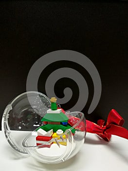 Merry Christmas and Happy New Year, colorful Xmas tree and tiny gift box toy decoration in the clear ball