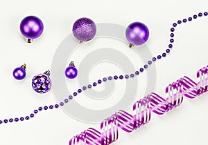 Merry Christmas and Happy New Year composition and decorations: Christmas toys, chaplet, pink ribbon