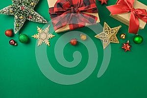 Merry Christmas and Happy New Year concept with gift box, ornaments and decorations on green background. Top view, flat lay
