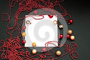 Merry Christmas and Happy New Year Decoration. Red and gold Bauble on Christmas black background. Winter time. Space for