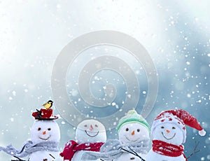 Merry christmas and happy new year greeting card with copy-space.Happy snowmen standing in winter christmas landscape.Snow