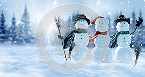 Merry Christmas and happy New Year greeting card with copy-space.Many snowmen standing in winter Christmas landscape.Winter