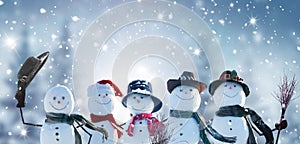 Merry Christmas and happy New Year greeting card with copy-space.Many snowmen standing in winter Christmas landscape.Winter