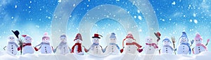 Merry Christmas and New Year greeting card with copy-space.Many snowmen standing in winter Christmas landscape.Winter