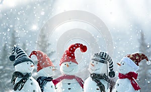 Merry Christmas and happy New Year greeting card with copy-space.Many snowmen standing in winter Christmas landscape.Winter