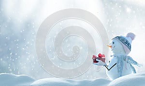 Merry Christmas and happy New Year greeting card with copy-space. Snow background. Two cheerful friends snowmen standing in winter