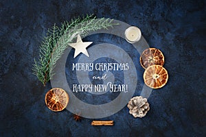 Merry Christmas and Happy New Year greeting card, a flat lay composition of a fir tree branch with xmas ornaments, shot from the