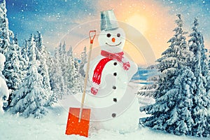 Merry christmas and happy new year greeting card .Funny snowman in a knitted scarf in a snowy forest.