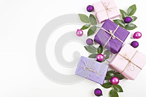Merry Christmas and Happy New Year greeting card. Gift boxes with pink and purple decorations on white background.