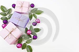 Merry Christmas and Happy New Year greeting card. Gift boxes with pink and purple decorations on white background.