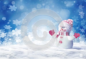 Merry christmas and happy new year greeting card. Happy snowman standing in winter christmas landscape.Snow background.