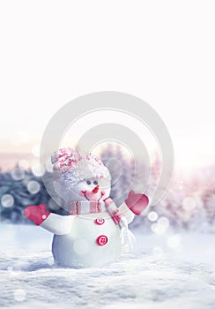 Merry christmas and happy new year greeting card. Happy snowman standing in winter christmas landscape.Snow background.