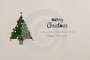 Merry Christmas and happy new year greetings in vertical top view cardboard with natural eco decorated christmas tree