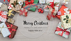 Merry Christmas and happy new year greetings in vertical top view wooden table full of christmas gifts presents.Xmas