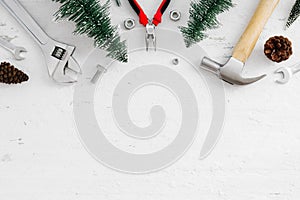 Merry Christmas and Happy new year handy tools and Christmas ornaments decoration on grunge white wood background concept. Top vi