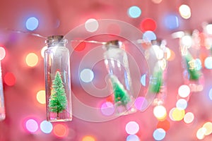 Merry Christmas and happy new year. Hanging small Christmas tree in glass jar on pine branches Christmas tree garland and