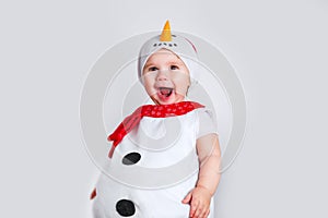 Merry Christmas and Happy New Year. Happy baby girl in snowman costume on white background