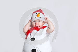 Merry Christmas and Happy New Year. Happy baby girl in snowman costume on white background