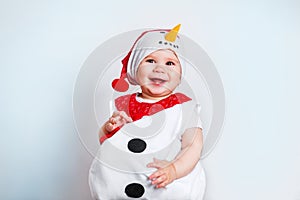 Merry Christmas and Happy New Year. Happy baby girl in snowman costume on white background