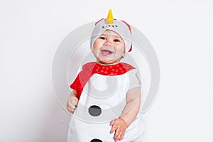 Merry Christmas and Happy New Year. Happy baby girl in snowman costume on white background