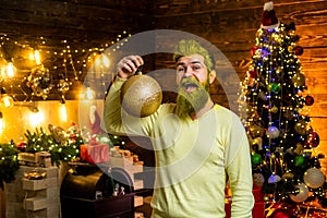 Merry Christmas and happy New Year. Happy winter time. Funny Santa. Portrait of Santa indoors with Christmas ball, gold