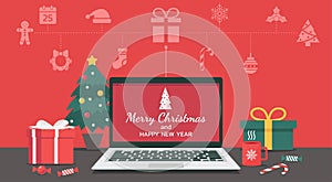 Merry Christmas and happy new year lettering on the laptop with Christmas icon and decorate with gifts
