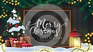 Merry Christmas and happy New Year, postcard with wooden wall, Christmas tree branches, garland, chalk board with lettering.