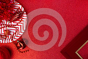 Merry christmas and happy new year red background.top view of tinsel,gift box,ball,ribbon decorate on sparkling table.holiday