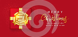 Merry Christmas and Happy New Year. Red gift box decor gold bow-ribbon, glitter golden isolated on red background. Top view.