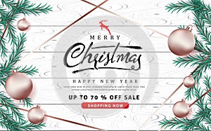 Merry Christmas and Happy New Year sale banner background with rose gold Christmas ball ornament