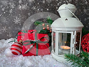 Merry Christmas and Happy New Year. Table decorated with Christmas gifts, holiday decorations and white lantern on snow