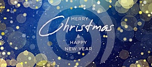 Merry Christmas & Happy New Year Text Design Over Magical Blue Defocused Bokeh Lights and Gold Glitter Background