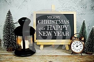 Merry Christmas and Happy New Year text message with alarm clock, LED candlelight and Christmas pine tree