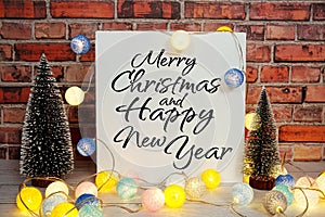 Merry Christmas and Happy New Year text message with LED cotton ball and pine tree