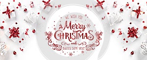Merry Christmas and Happy New Year text on white background with Christmas gift boxes, red ribbons, silver decoration, bokeh,